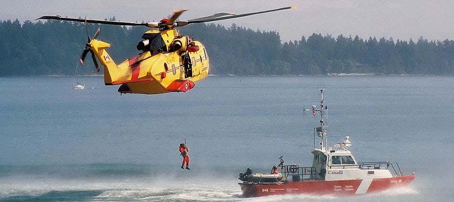 Helicopter picking up rescuer from water