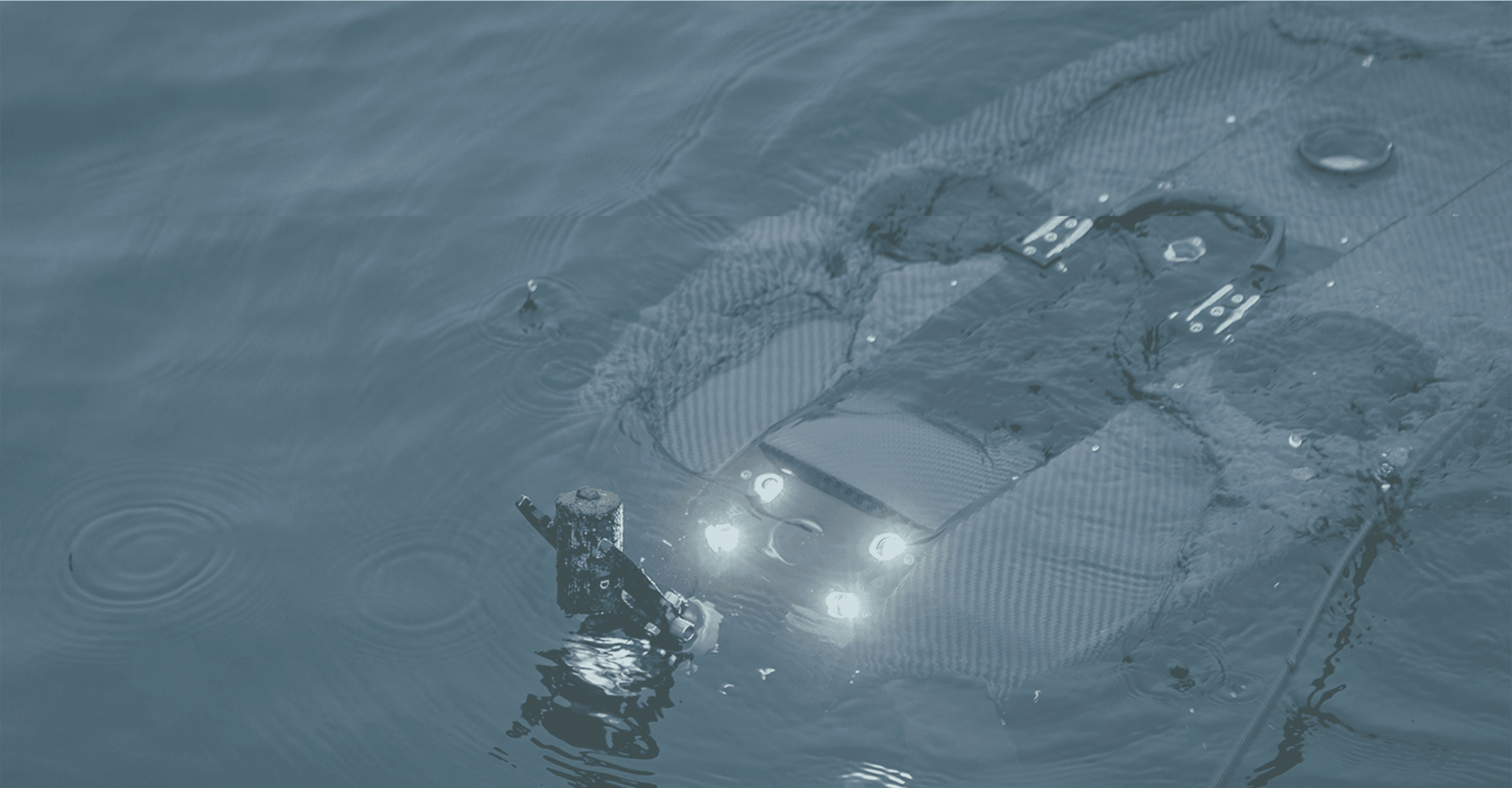 REV grabbing a battery in the water