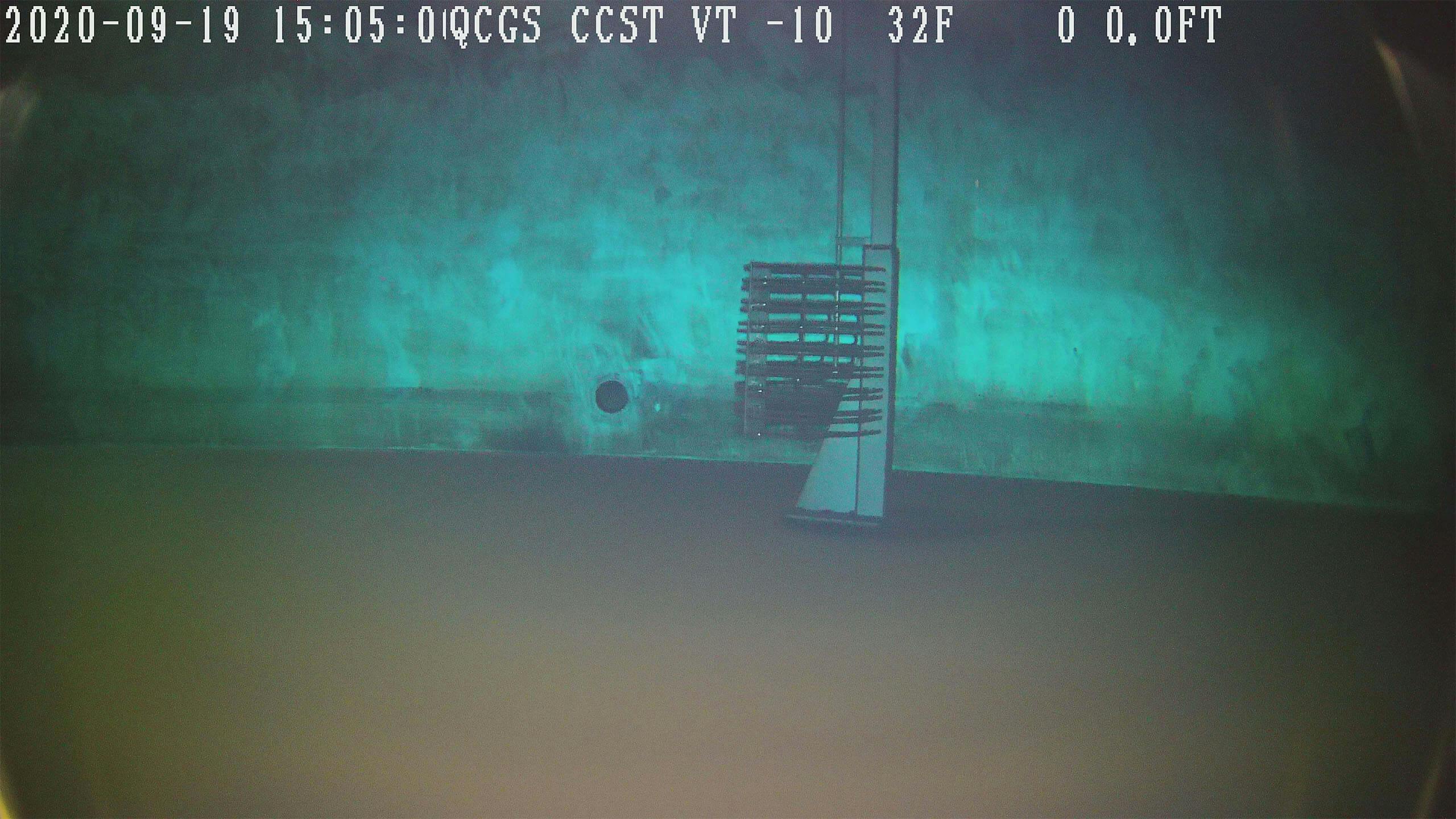 Underwater image taken with a DTG3 underwater ROV showing the inside of a blue water tank and silver ladder. 