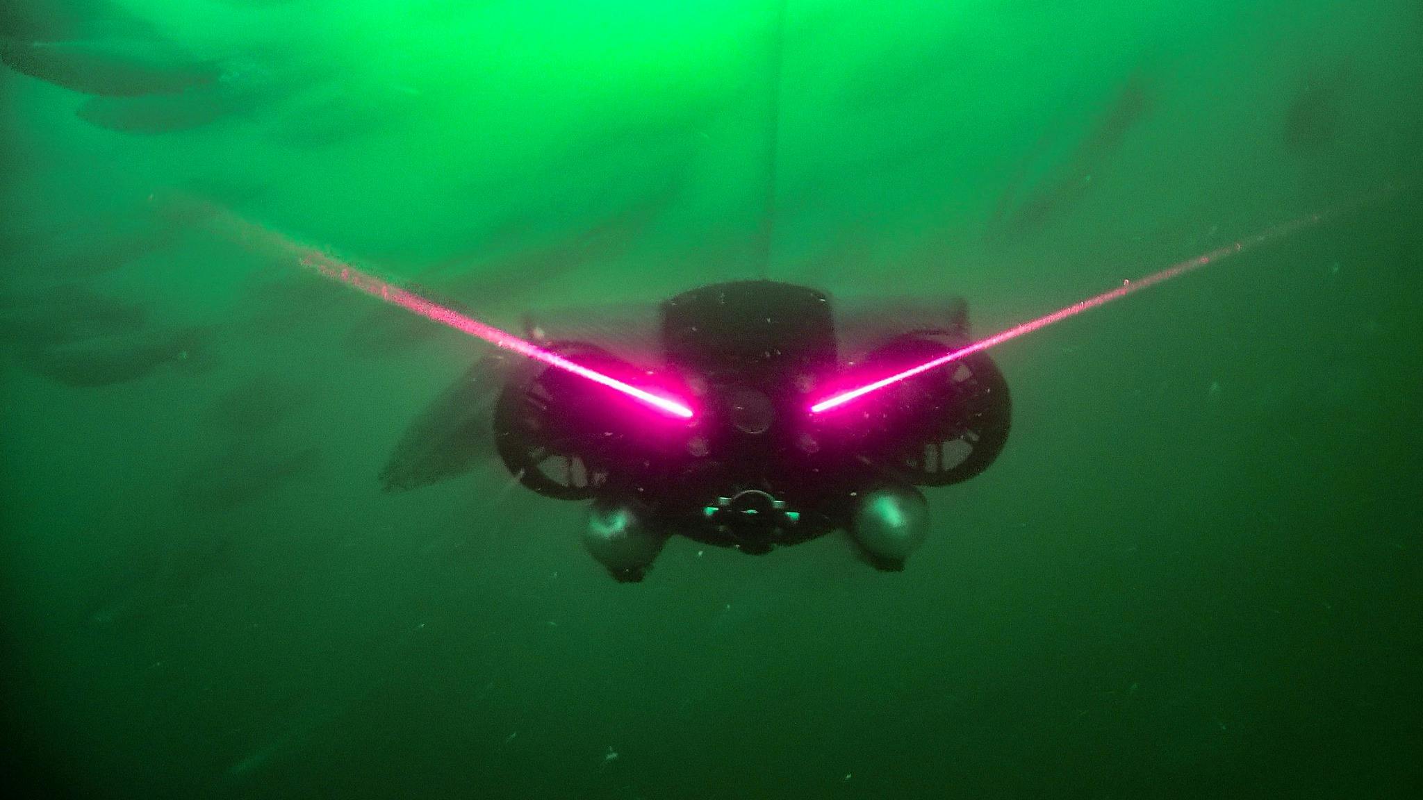Deep Trekker REVOLUTION ROV underwater with laser beams coming from the front