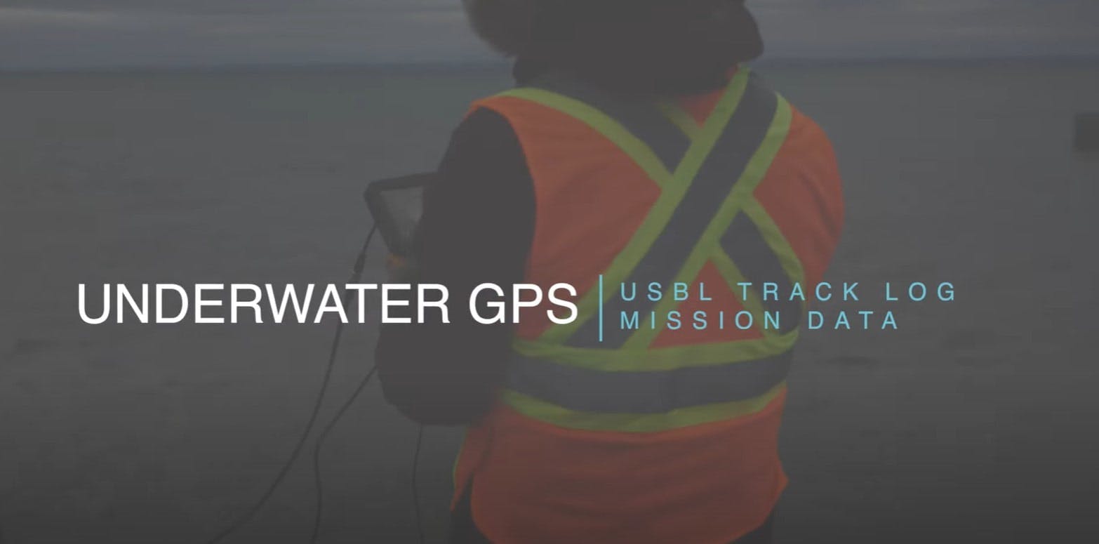 Person in PPE jacket standing on a dock with their back to the camera. Title overlaid saying "Underwater GPS: USBL track log mission data"