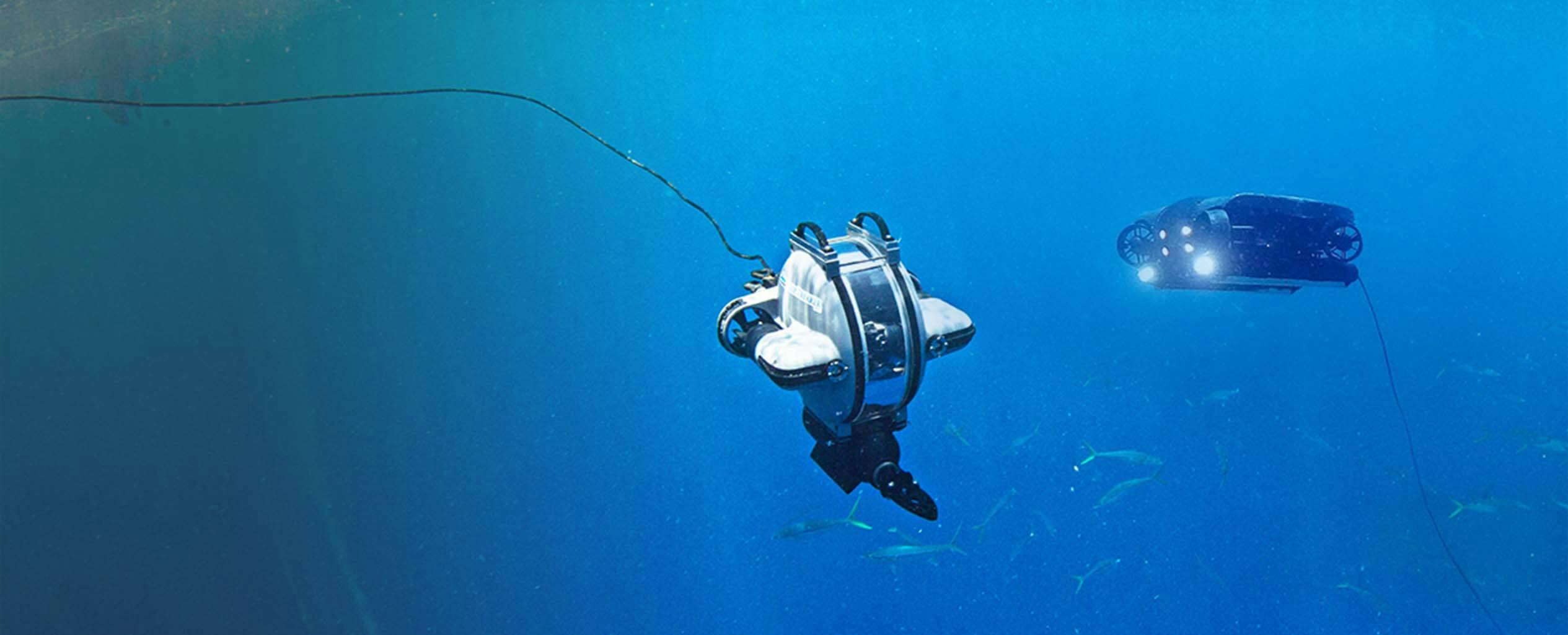 Deep Trekker's underwater ROVs the DTG3 and the REVOLUTION swimming underwater in open water